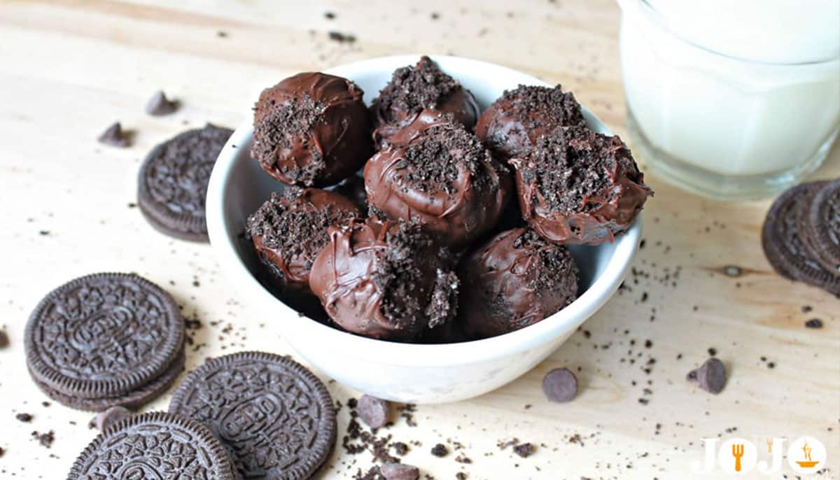 Delicious chocolate-covered Oreo truffles with cookie crumble topping Homemade Oreo truffles coated in chocolate and topped with crushed cookies in a white bowl