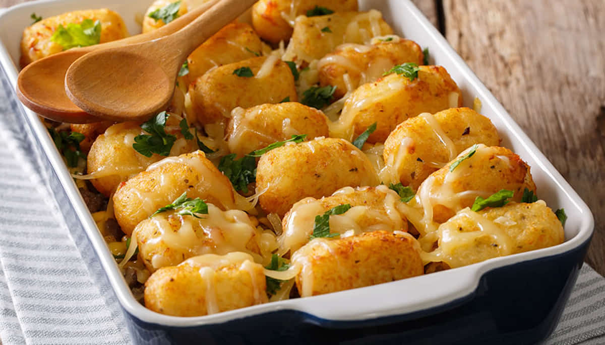 Crispy Tater Tot Casserole with ground beef and melted cheddar cheese served in a baking dish for an easy family dinner