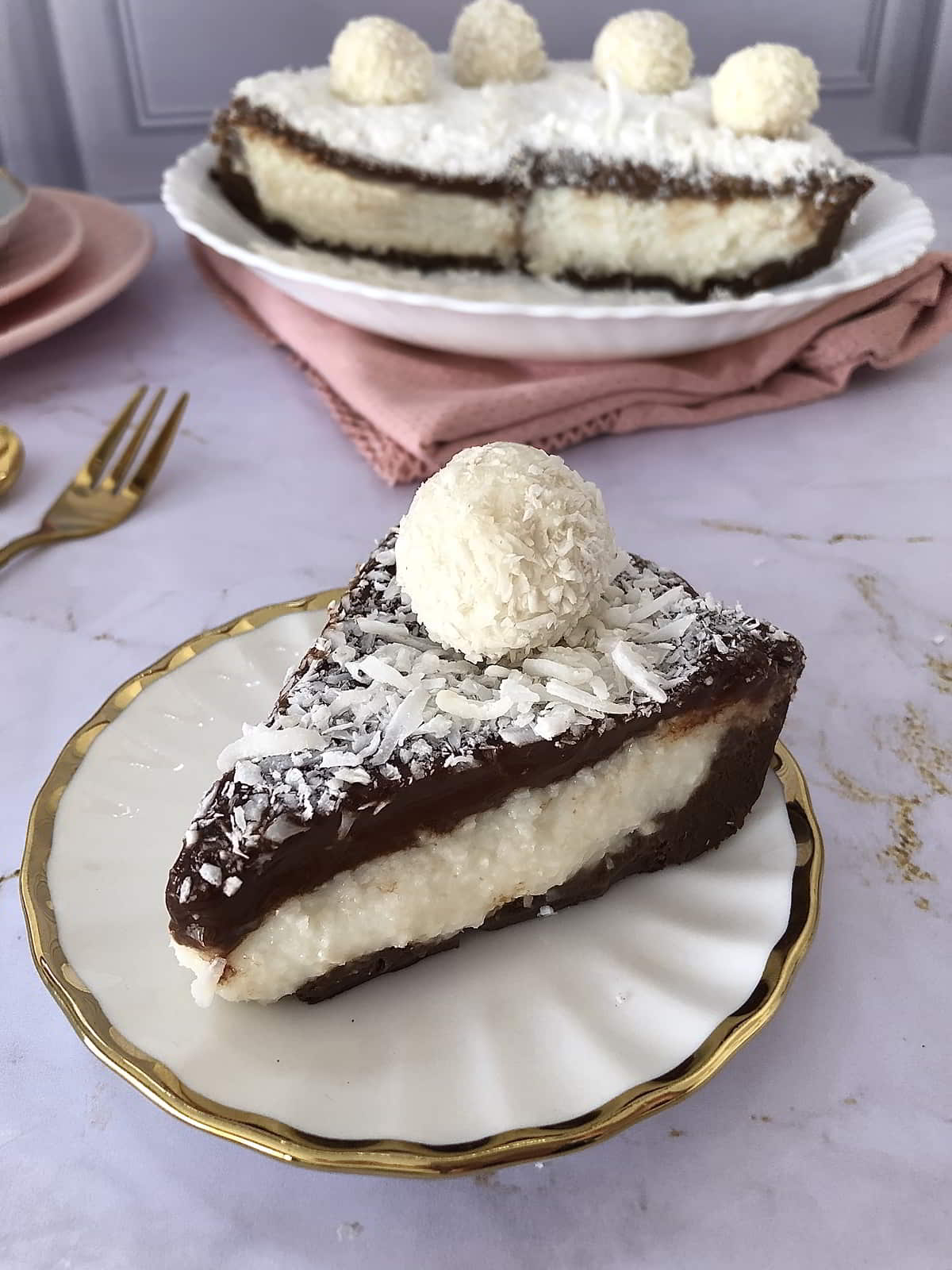 Slice of Coconut Cream Pie with Chocolate Ganache and shredded coconut on top, served on a white plate – soft layers and rich coconut flavor.