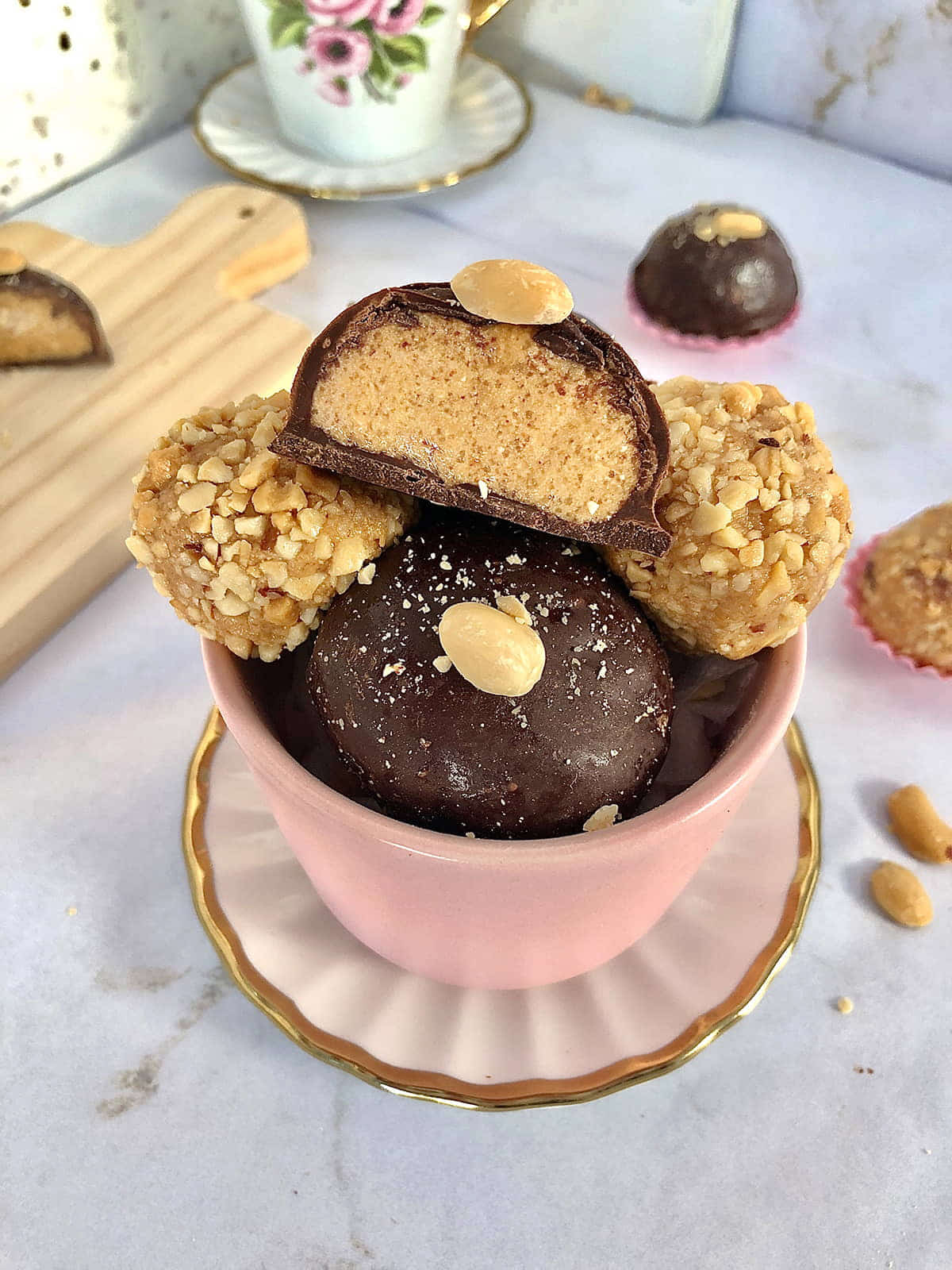 Creamy peanut butter balls recipe showing a soft peanut butter center with a firm chocolate coating and roasted peanut topping