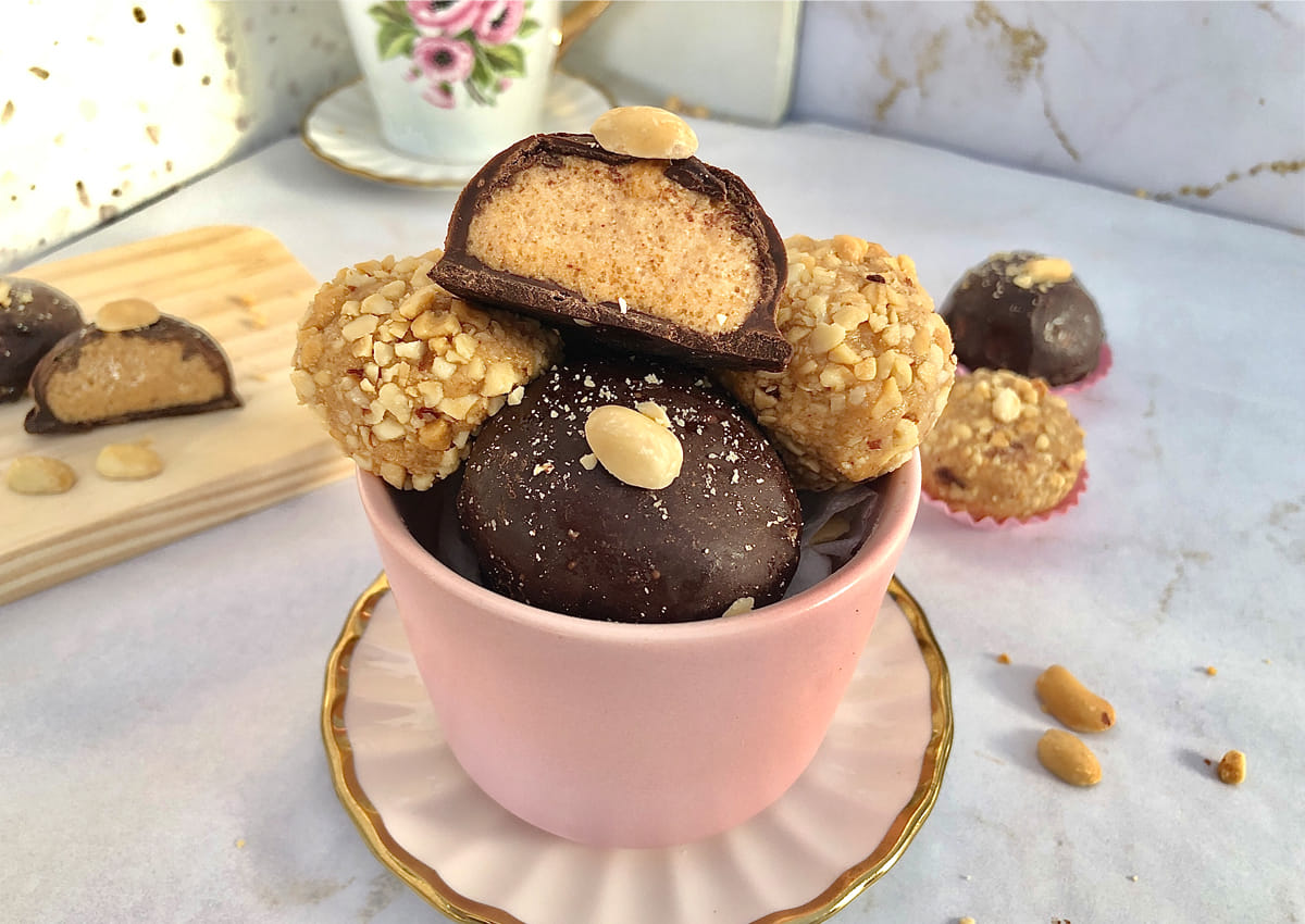 Homemade peanut butter balls recipe with chocolate coating and roasted peanuts served as a classic American no bake treat