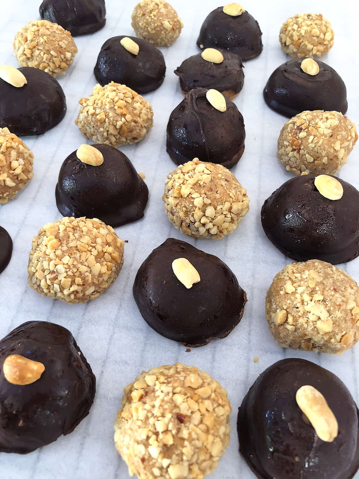 Soft peanut butter balls recipe made with a creamy peanut butter filling, chocolate coating, and chopped peanuts for a smooth homemade candy texture