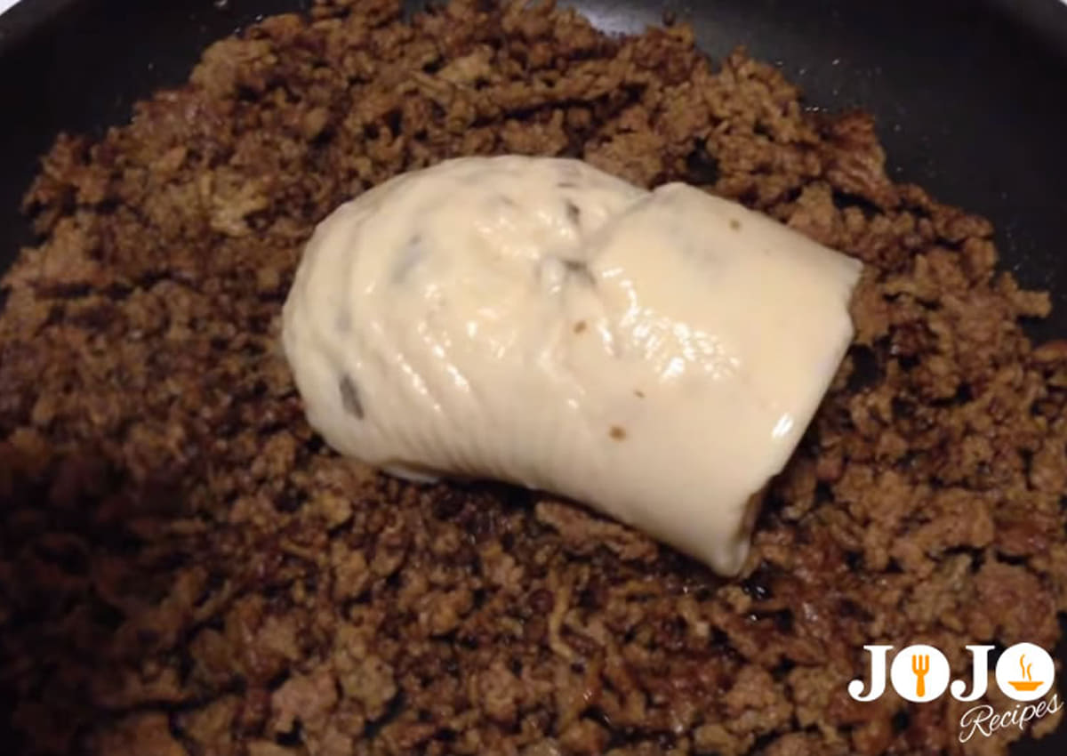 Cream of mushroom soup added to seasoned ground beef for Tater Tot Casserole filling