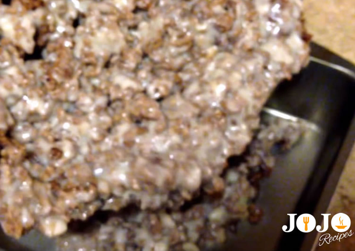 Creamy ground beef mixture spread into a baking dish for Tater Tot Casserole