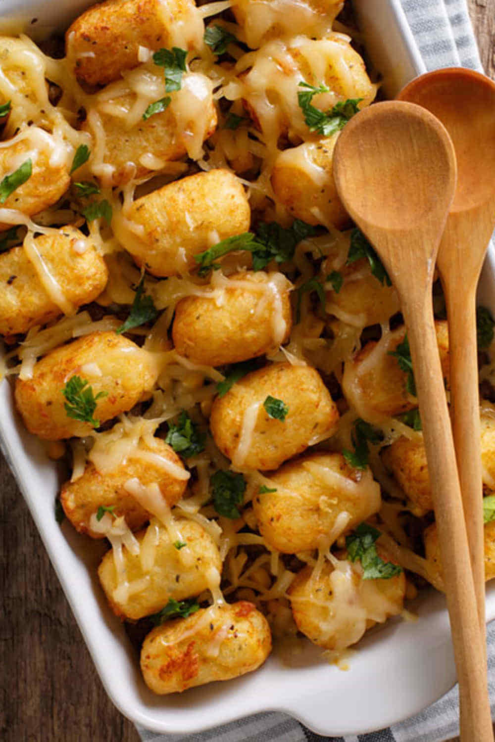 Crispy Tater Tot Casserole with ground beef and melted cheddar cheese in a baking dish