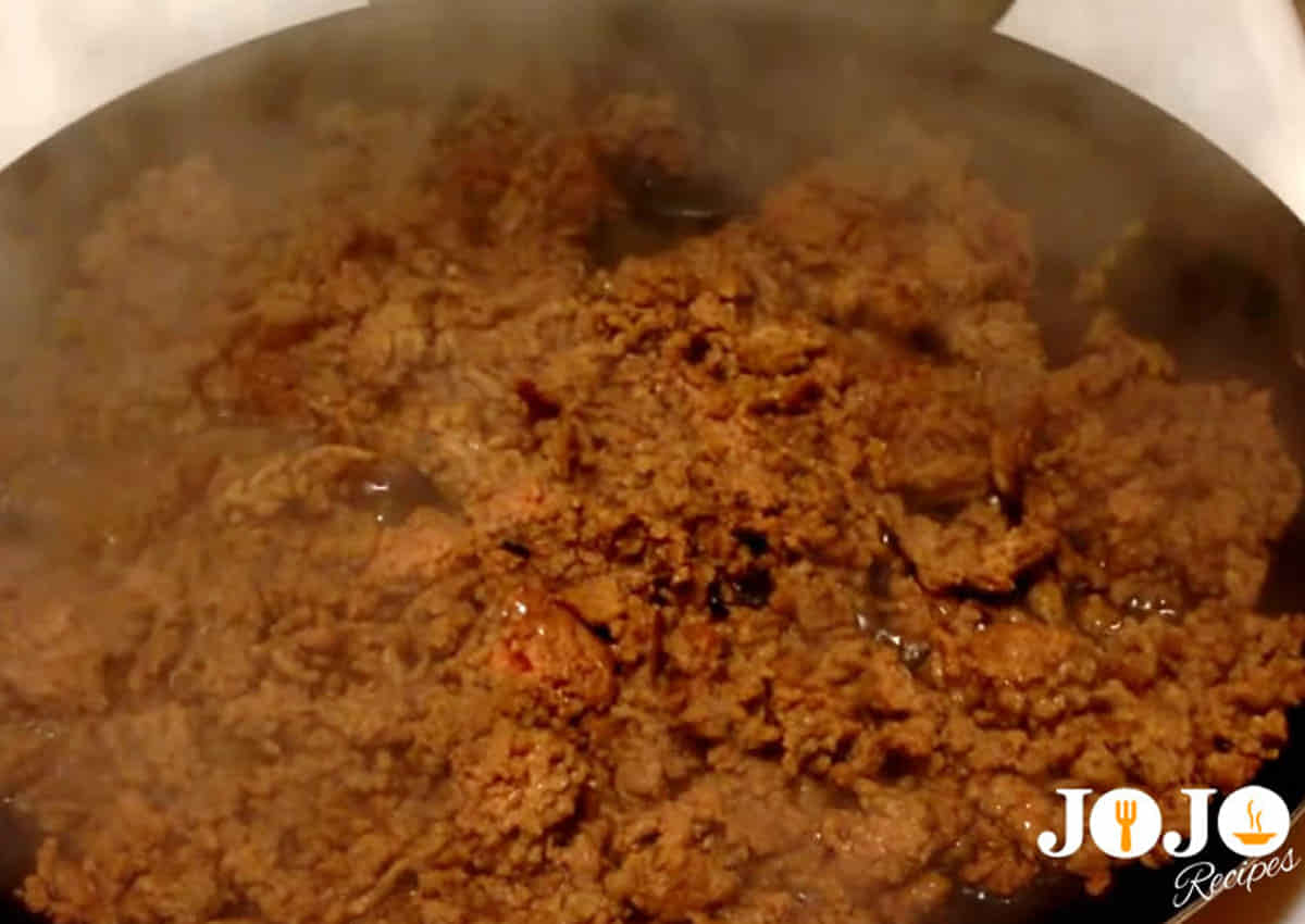 Seasoned ground beef cooking in a skillet for Tater Tot Casserole filling
