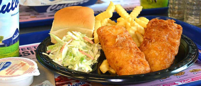 A delicious plate of food awaits on a table, showcasing Culver's 2-Piece Cod Dinner. Get ready to savor this mouthwatering meal!